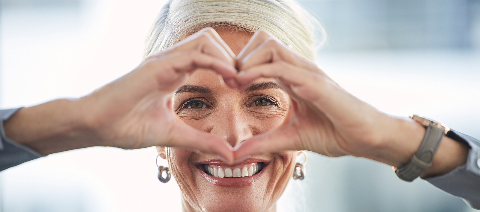 woman making heart shape with hands